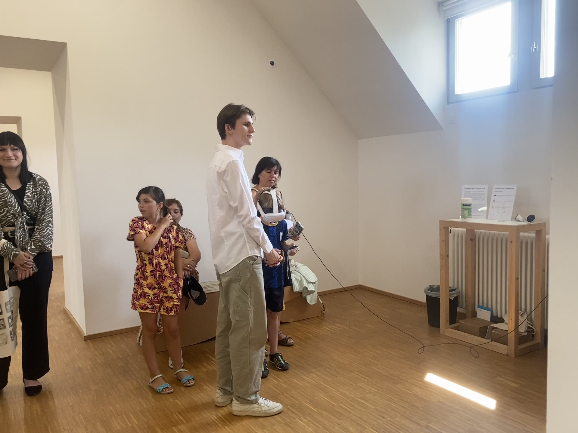 Visitors gathered around a child using the Hermann Sprauer VR station